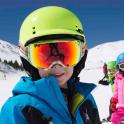 a group of children wearing helmets and goggles on a ski slope