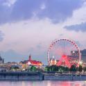 a ferris wheel in front of a city at night