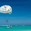 a group of people on a parachute over the ocean