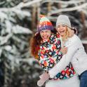 two women are hugging each other in the snow