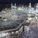 a large group of people praying in the grand mosque at night