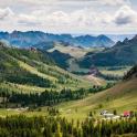 a view of a valley with mountains and trees