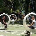 a group of people sitting in white rings on a playground
