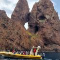 a group of people on a boat in front of a mountain