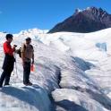 three men standing on top of a snow covered mountain