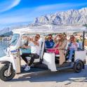 a group of people riding in a golf cart