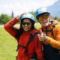 a man and woman wearing helmets posing for a picture