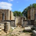 an ancient building with ruins in a field