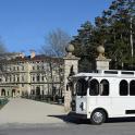 a white bus parked in front of a building