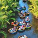 a group of people riding in boats down a river