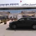 a black car parked in front of a hospital