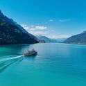 a boat on a lake with mountains in the background