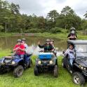 a group of people standing on atvs