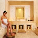 a woman sitting on a tub in a bathroom