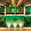 a room with green lighting and a dance floor