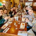 a group of people sitting at a table with wine glasses