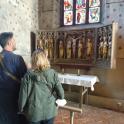 a man and a woman looking at a altar in a church