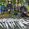a group of people standing next to a group of fish