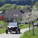 an old car driving down a road with two other cars