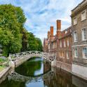 a bridge over a river between two buildings