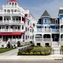 a row of houses with white balconies on a street