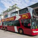 two red double decker buses parked in front of a building