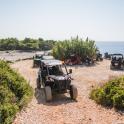 a group of atvs parked on a dirt road near the ocean
