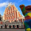 a large building with a teddy bear in front of it