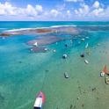 an aerial view of a beach with boats in the water
