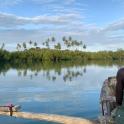 a man is sitting in a boat on a river