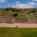 an aerial view of a castle with a green field