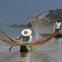 a man in a boat with a net in the water