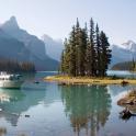 a boat on a lake with mountains in the background