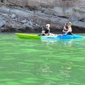 two people are in a kayak in the water