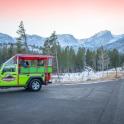 a green truck parked on the side of a road