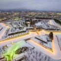 an aerial view of a park covered in snow at night