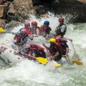 a group of people in a raft in a river