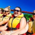 a group of people in a boat on the water