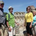 a group of people standing in front of the coliseum