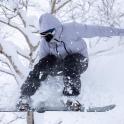 a person on a snowboard jumping in the snow