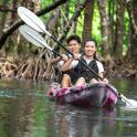 two people are sitting on a raft in the water
