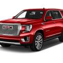 a red gmc acadia against a white background