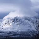a mountain covered in snow on a cloudy day