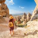 a woman walking through a rock formation