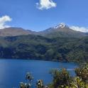 a large blue lake with a mountain in the background
