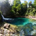 a group of people standing around a pool of water