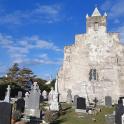 an old church with tombstones in a cemetery