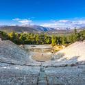 an amphitheater with mountains in the background