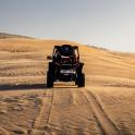 a person riding a quad bike in the desert