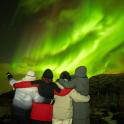 a group of people looking at the northern lights